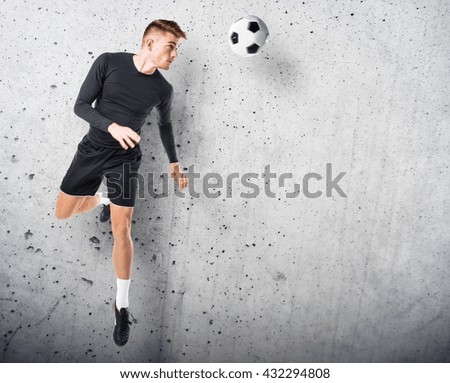 Young blonde man playing football
