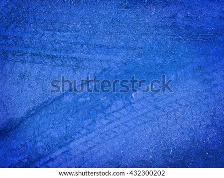 Tire tracks on the blue road gravel stone background 