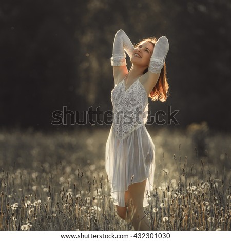 Young woman in a beautiful lace dress in nature
