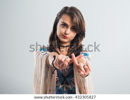 Young girl doing NO gesture over grey background