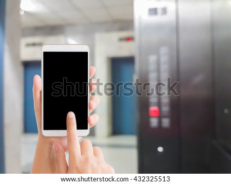 woman use mobile phone and blurred image of the elevator in the hospital