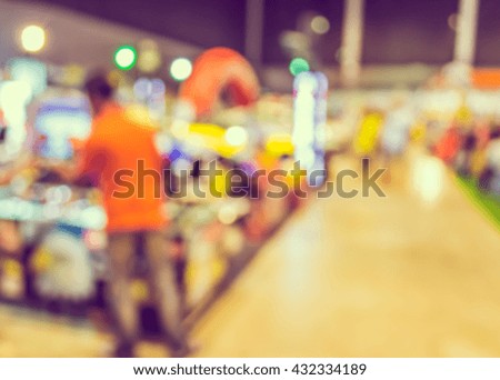 blurred image of shopping mall or tradeshow and people for background usage .