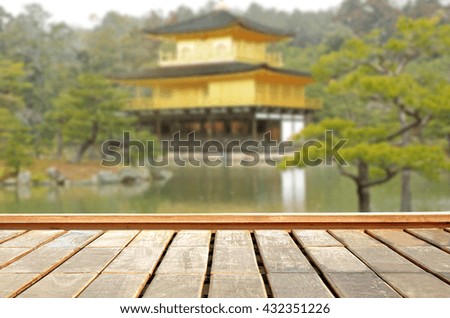 wooden floor with golden japanese castle blurred as background