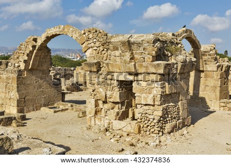 Ruins of Forty Columns Castle, a Frankish castle built in 13th century near Paphos harbour, Cyprus. The Archaeological Park of Kato Paphos. Orthodox Agioi Anargyroi Church in the background.