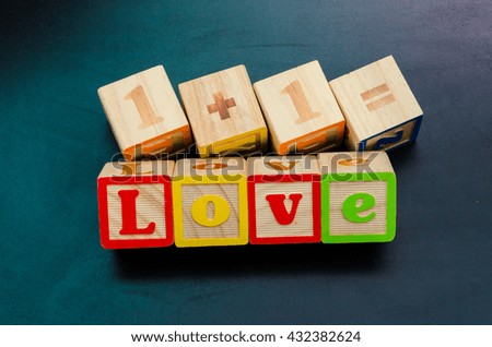 Word 'love' from wooden alphabet blocks with letters.