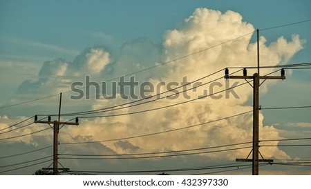 The electric poles in clouds and blue sky background.