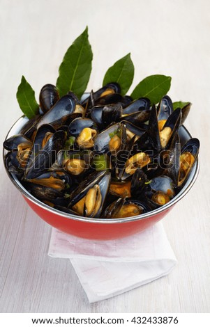 Fresh homemade cooked mussels with carrots and leek in a bowl