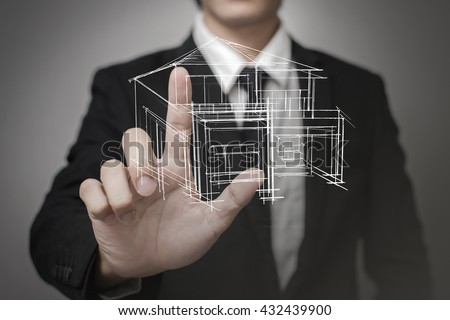 Businessman touching virtual screen a model of the house