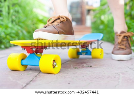 Close-up skateboarder boy riding outdoor. Skatebord at city, street. Shoes, stylish sneakers. Skate wheels. Size. Longboard. Cool, Fun Teenager. Skateboarding at Summer