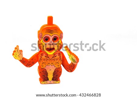 Plastic Toy Animal, funny monkey with banana isolated on a white background