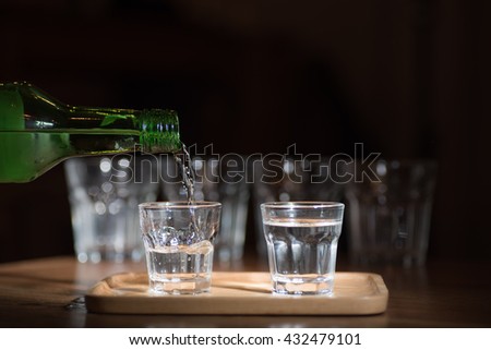 soft focus image for sake.
Sake -flavored soft sweet scent was poured from a bottle into a small glass on darken background .Ideal for celebrations. Royalty-Free Stock Photo #432479101