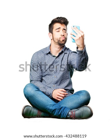 man sitting on the floor taking a selfie