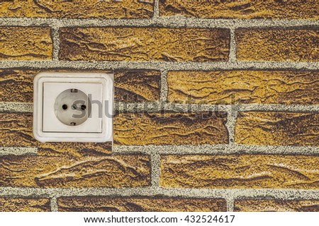 white power switch on the orange brick photo wallpaper background