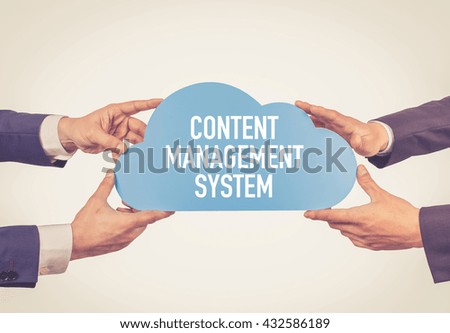 Two men holding cloud with Content Management System text