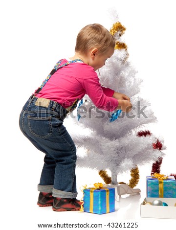 The small beautiful girl decorates a Christmas tree on a white background.