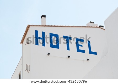 signage of hotel on wall of white building