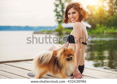Beautiful woman with black bikini relaxing on the beach. Happy day, summer day, Sunshine Girl with little dog
