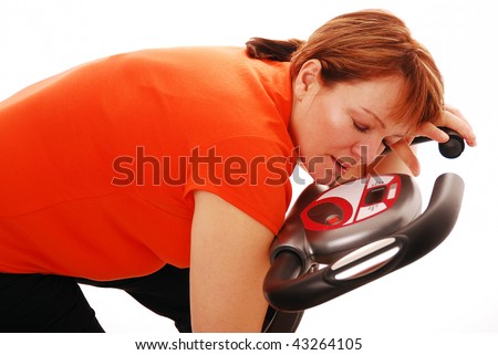 Exhausted woman asleep of exercise bike Royalty-Free Stock Photo #43264105