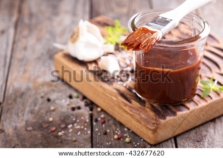 Barbeque sauce with a basting brush in a jar Royalty-Free Stock Photo #432677620