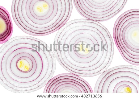 Abstract background is illuminated by red onion slices lying next to each other isolated on white background