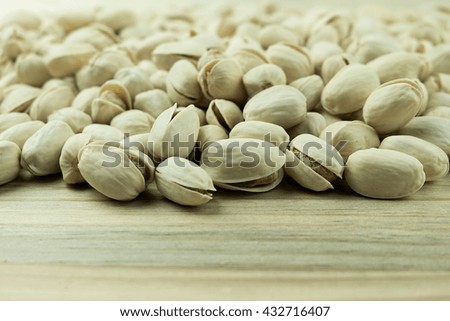 Pistachios nut on wooden table or floor background