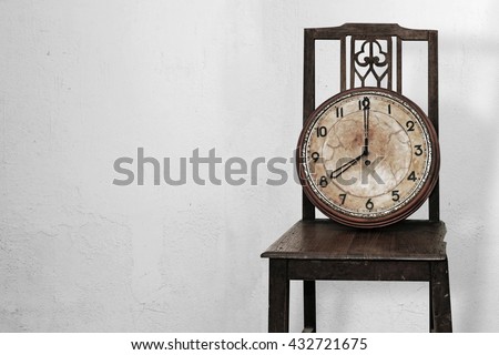 Antique clock on old wooden chairs. , Line of business must race against the clock.
