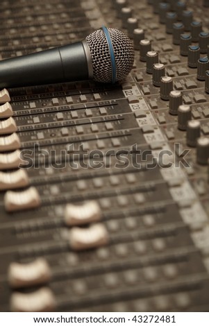 microphone on old dirty sound mixer panel. microphone in focus