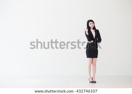 business woman show thumb up with white wall background, great for your design or text, asian
