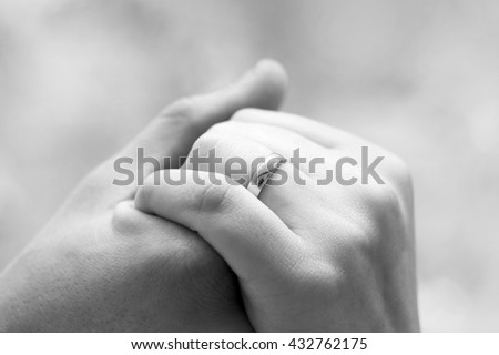black and white art wedding photography monochrome bride and groom with wedding rings on their hands, young couple holding hands, male and female hand with wedding rings, wedding ceremony 