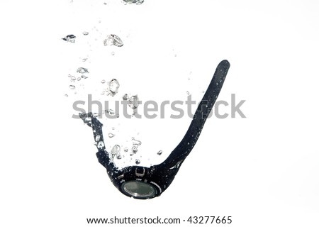A black digital watch falling into clear water