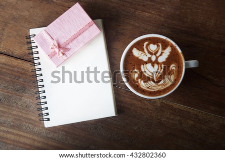 Pink Gift box coffee and blank notepad on wooden background