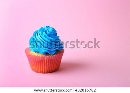 Birthday cupcake on light pink background