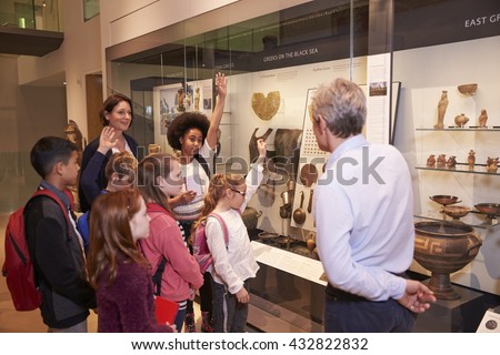 Students Looking At Artifacts In Case On Trip To Museum Royalty-Free Stock Photo #432822832