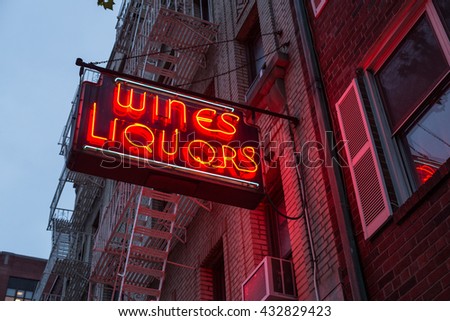 Liquor store neon sign on brick building background