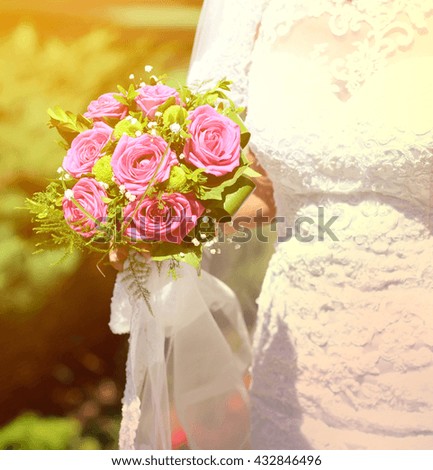 Bride holding beautiful rose bouquet