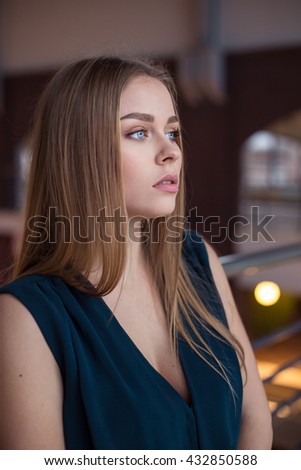 Beautiful young businesswoman against urban city background.
