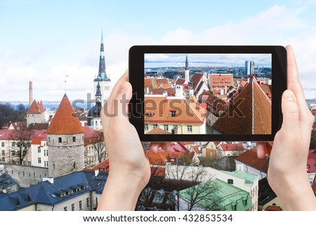 travel concept - tourist photographs Tallinn city skyline, Estonia on tablet pc