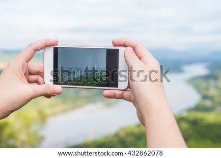 female traveler take a photo river mountain view