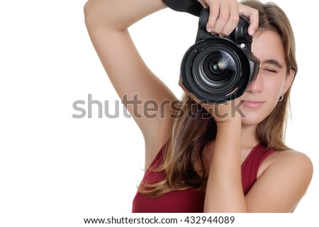 Teenage girl taking photographs with a professional camera isolated on a white background