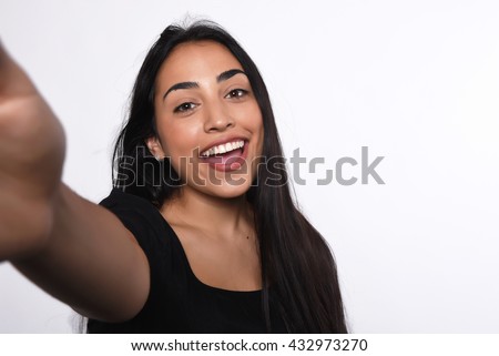 Close-up of young beautiful woman taking selfie. Isolated white background Royalty-Free Stock Photo #432973270