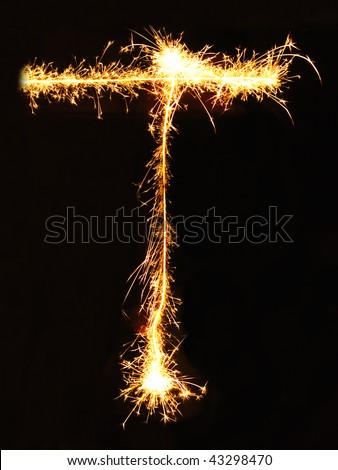 Letter T made of sparklers isolated on black