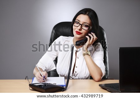 Adult young pretty business woman working at her office