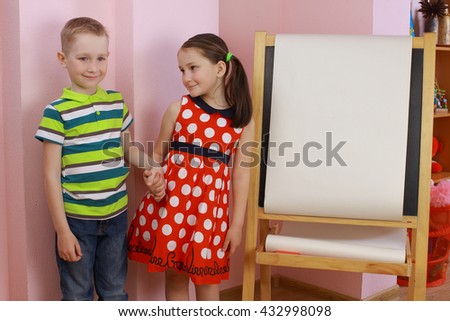 the development of emotional intelligence. child psychology. girl and boy depict different emotions. against the background of the drawing board. love between a boy and a girl