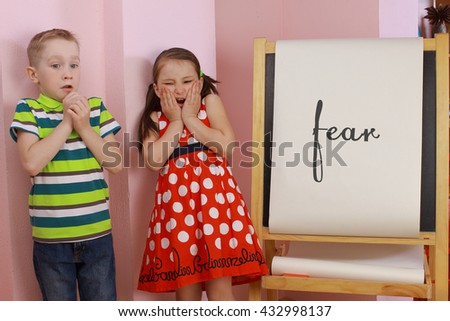 the development of emotional intelligence. child psychology. girl and boy depict different emotions. against the background of the drawing board
