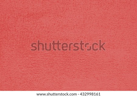 Background of a dark pink stucco coated and painted exterior, rough cast of cement and concrete  wall texture, decorative coating 