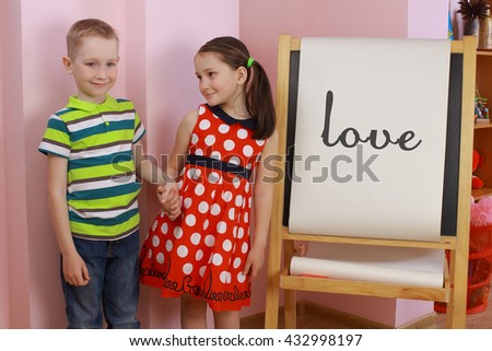 the development of emotional intelligence. child psychology. girl and boy depict different emotions. against the background of the drawing board. love between a boy and a girl