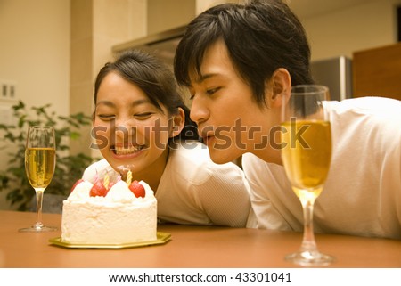 A young couple smiling and cheers