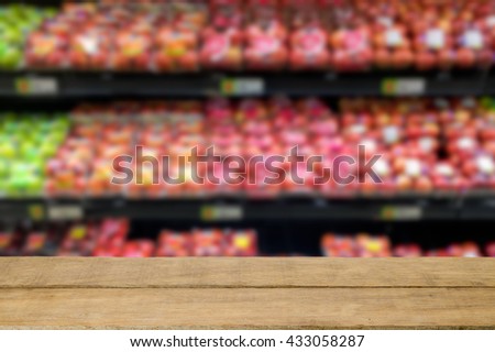 Fruit store in supermarket blurred background with empty wooden top table. For product display