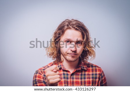 man shows a fig at the