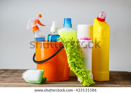 Bucket with cleaning items on light background Royalty-Free Stock Photo #433131586